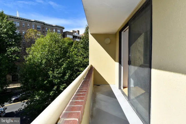 a view of balcony with lots of green space