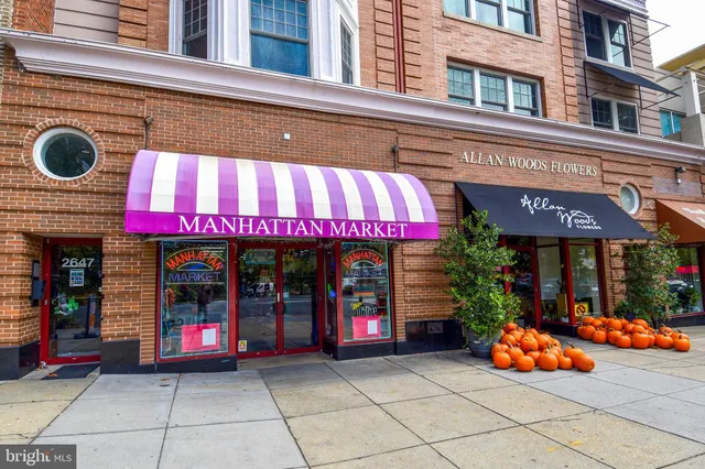 a front view of multi story commercial building with retail shops