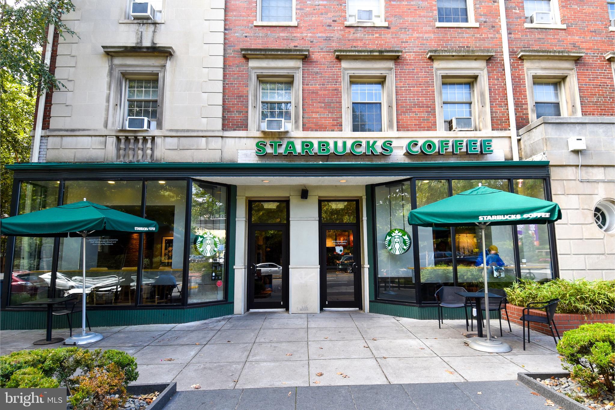 2725 Connecticut Avenue Northwest, Unit 403 Washington, DC 20008 - Photo 24 of 25 a view of a cafe with a table and chairs under an umbrella