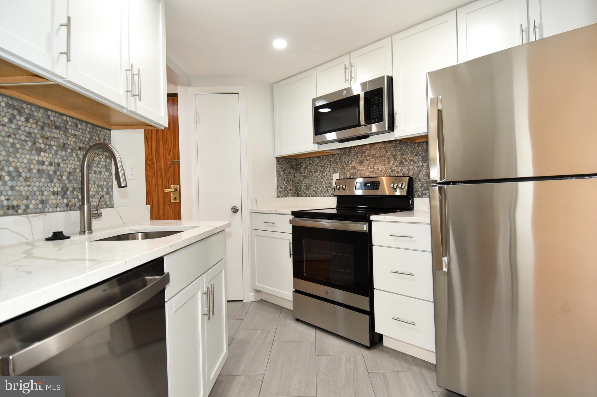 2725 Connecticut Avenue Northwest, Unit 403 Washington, DC 20008 - Photo 6 of 25 a kitchen with a refrigerator sink and microwave