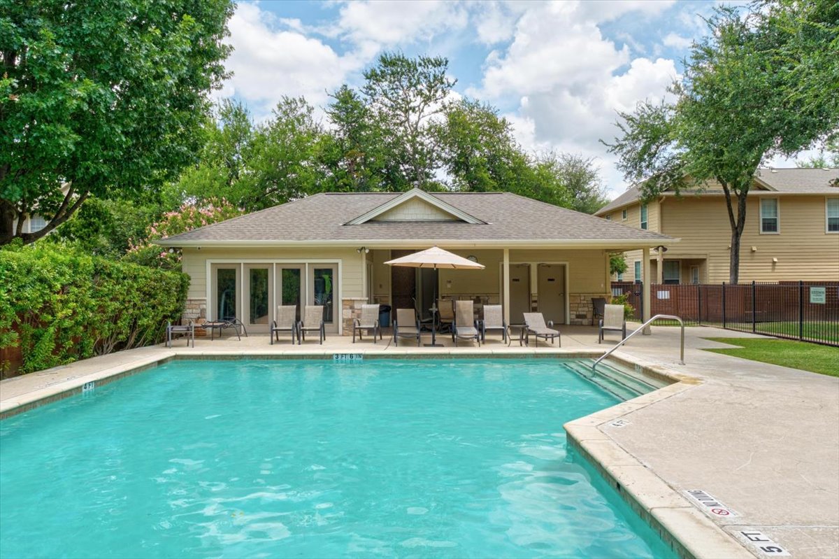 11000 Anderson Mill Road, Unit 11 Austin, TX 78750 - Photo 29 of 34 A sparkling pool with an adjacent covered patio offers a refreshing oasis for relaxation and leisure.