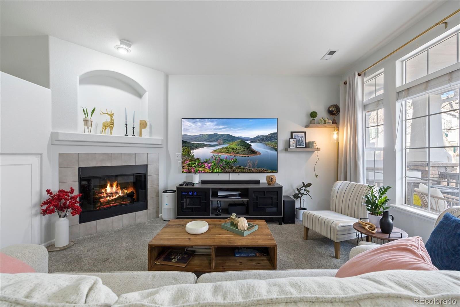 8419 Stonybridge Circle Highlands Ranch, CO 80126 - Photo 1 of 24 a living room with furniture and a fireplace
