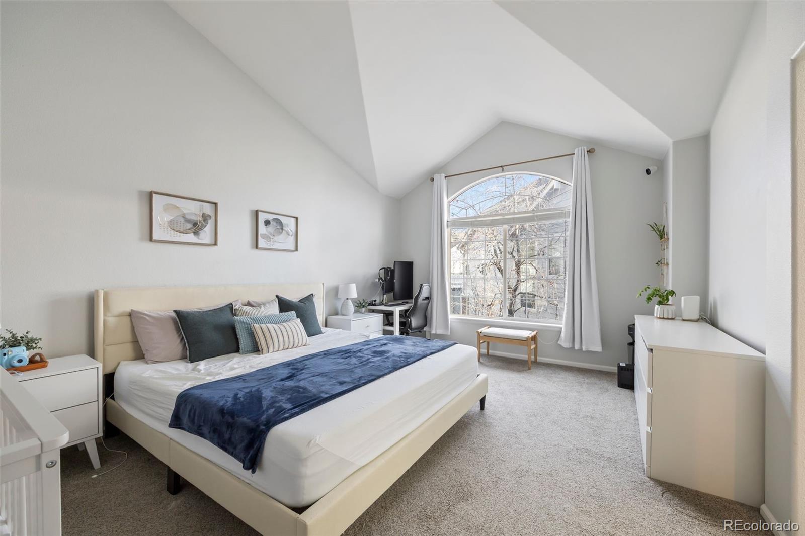8419 Stonybridge Circle Highlands Ranch, CO 80126 - Photo 12 of 24 a spacious bedroom with a bed and a large window