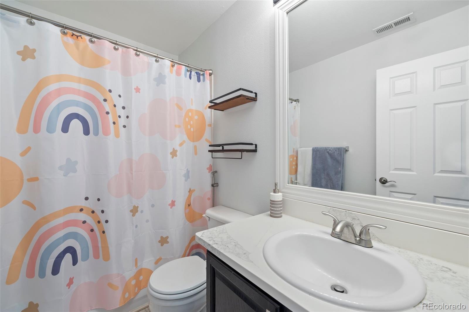 8419 Stonybridge Circle Highlands Ranch, CO 80126 - Photo 18 of 24 a bathroom with a sink a toilet and a mirror
