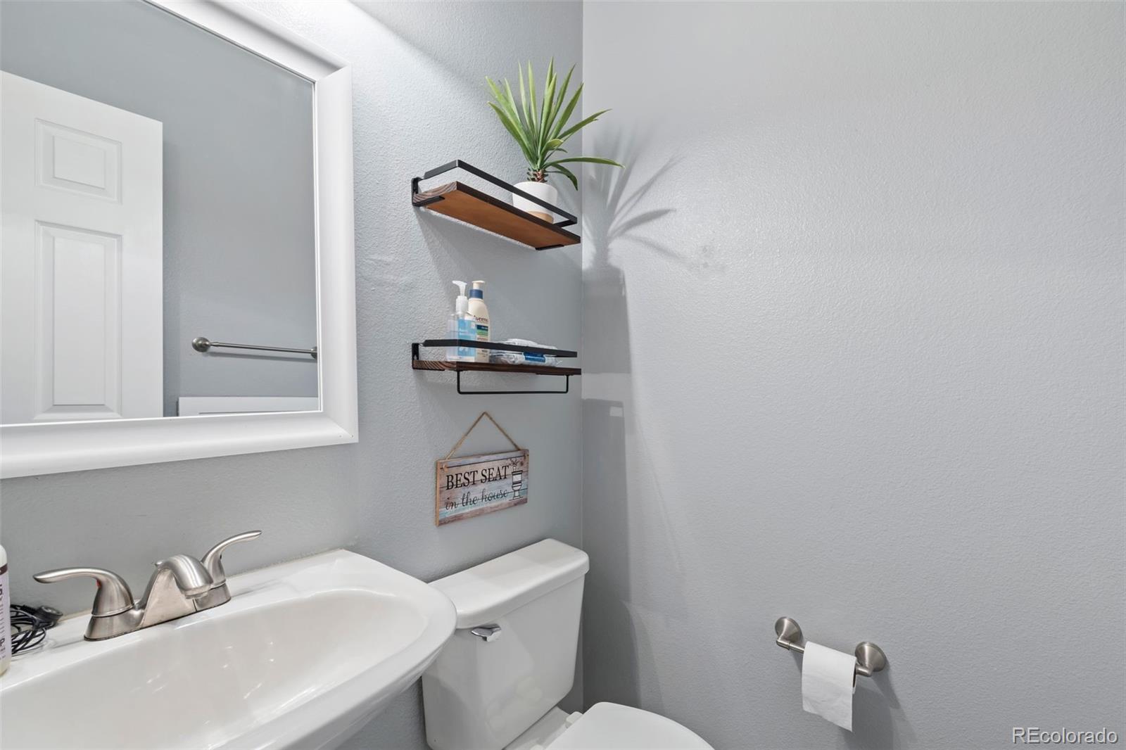 8419 Stonybridge Circle Highlands Ranch, CO 80126 - Photo 19 of 24 a bathroom with a toilet sink and mirror