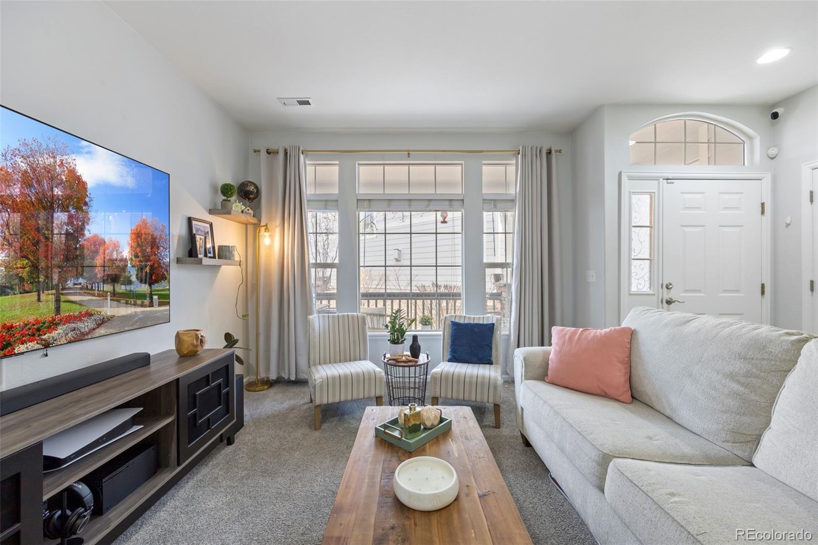8419 Stonybridge Circle Highlands Ranch, CO 80126 - Photo 8 of 24 a living room with furniture and a floor to ceiling window