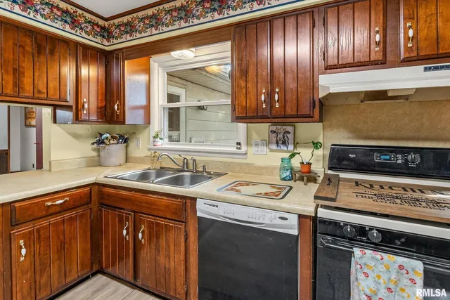 a kitchen with stainless steel appliances granite countertop a sink stove and cabinets