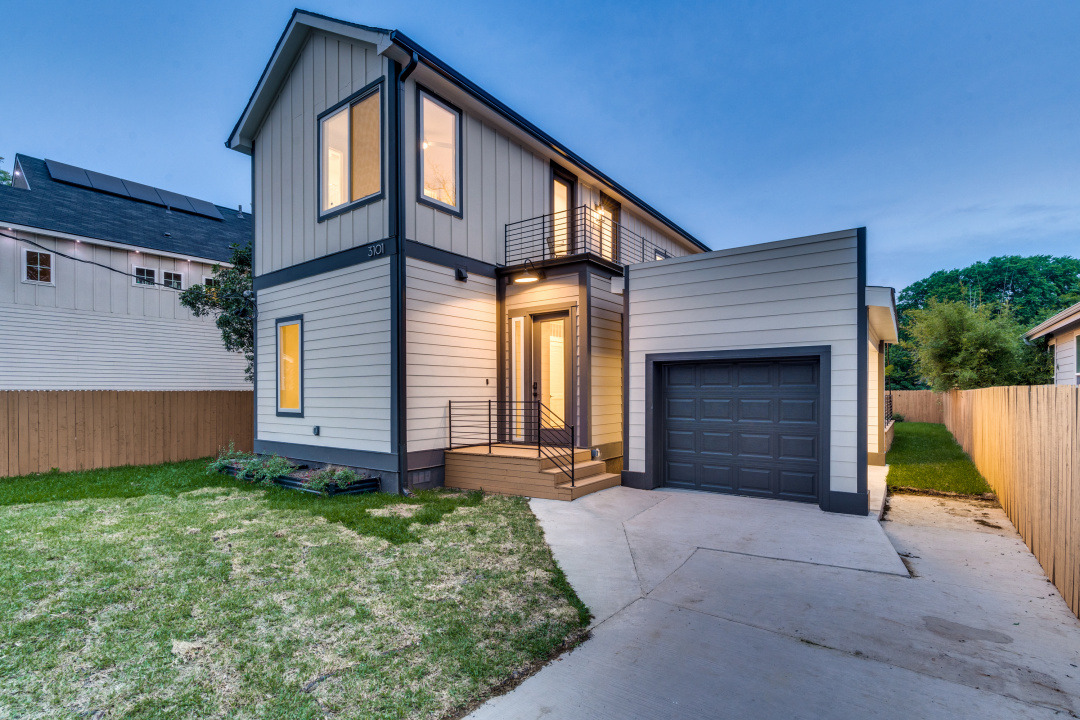 3101 Lyons Road Austin, TX 78702 - Photo 1 of 11 a front view of a house with a yard and garage