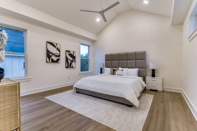 a bedroom with a bed and painting on the wall