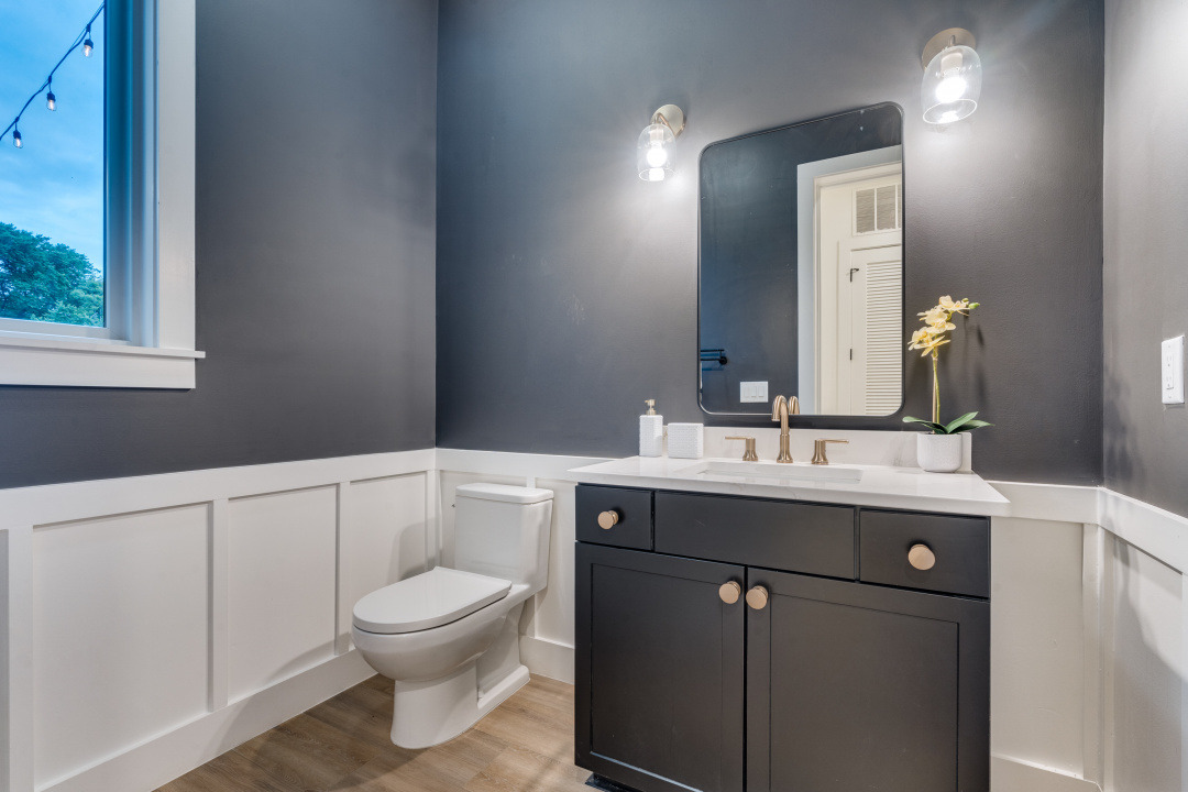 3101 Lyons Road Austin, TX 78702 - Photo 9 of 11 a bathroom with a toilet a sink and a mirror