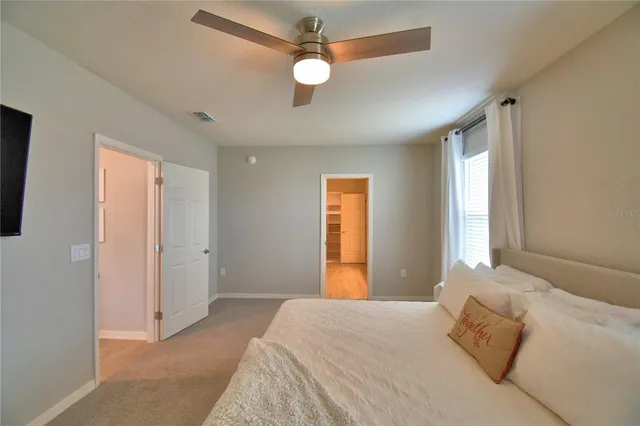 a bedroom with a bed and a book shelf
