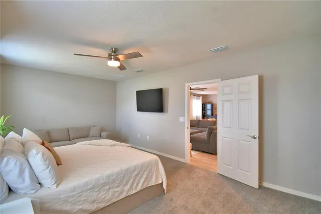 a en suite bathroom with a granite countertop sink and a mirror