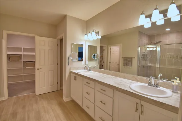 a view of a hallway with wooden floor and closet
