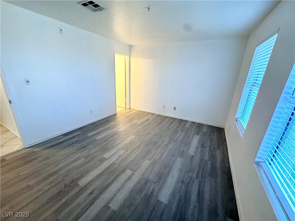2064 Mesquite Lane, Unit 102 Laughlin, NV 89029 - Photo 10 of 22 Empty room with dark wood finished floors and baseboards