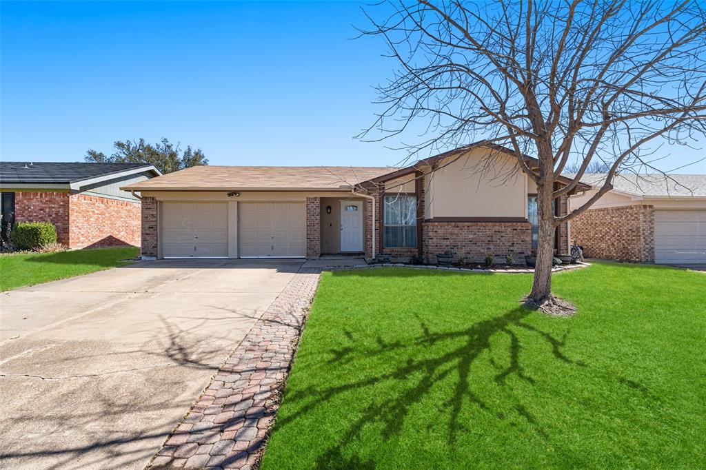 a front view of a house with a garden and yard