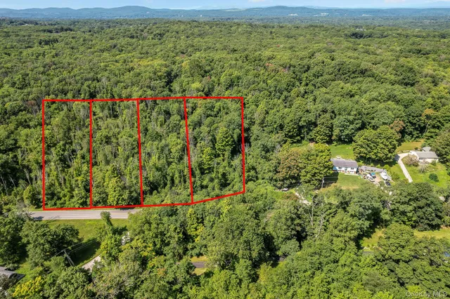a view of a green field with lots of bushes