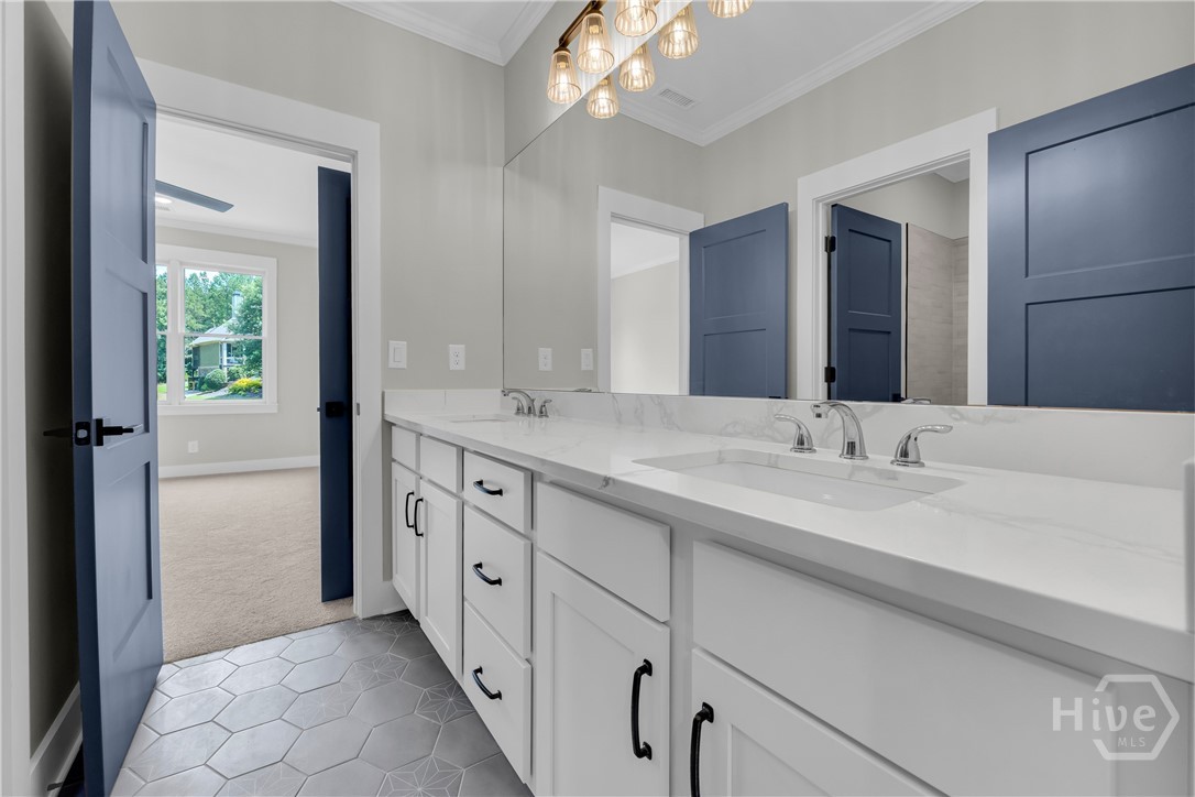 2476 St Martin Way Monroe, GA 30656 - Photo 60 of 75 Spacious bathroom featuring a dual vanity with white cabinetry, polished chrome fixtures, and a large mirror
