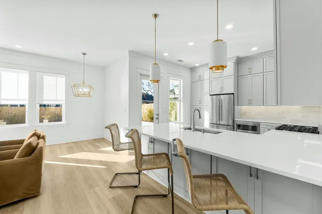 a room with stainless steel appliances kitchen island granite countertop furniture and a kitchen view