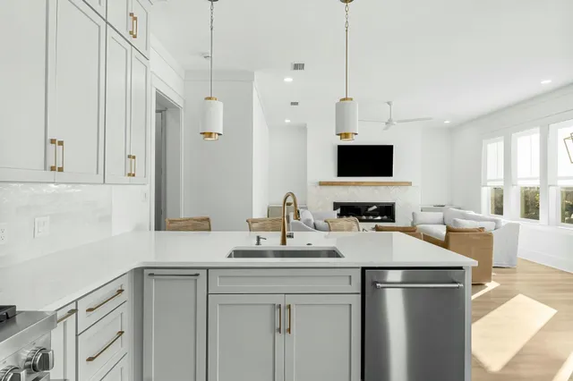 a kitchen with stainless steel appliances a sink stove and refrigerator