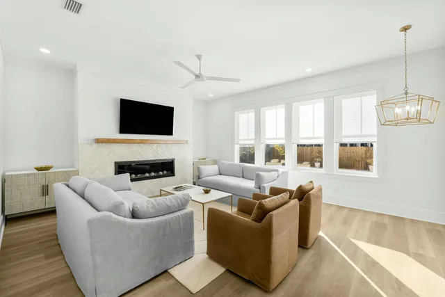 a living room with fireplace furniture and a flat screen tv