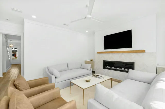 a living room with a couch a flat screen tv and a fireplace