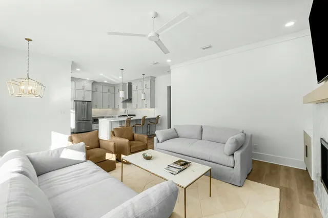 a living room with furniture and kitchen view