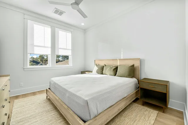 a large bed sitting in a bedroom next to a window