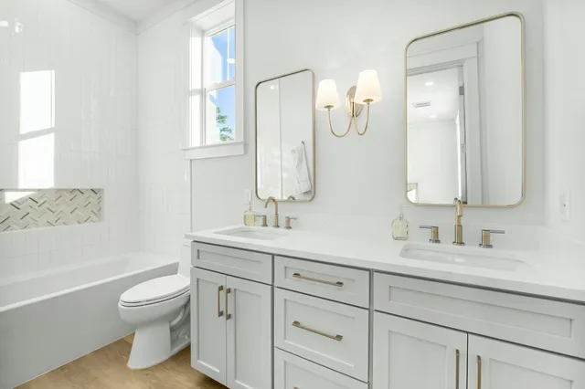 a bathroom with a toilet a sink and a mirror