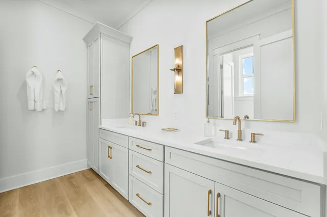 a bathroom with a double vanity sink mirror and
