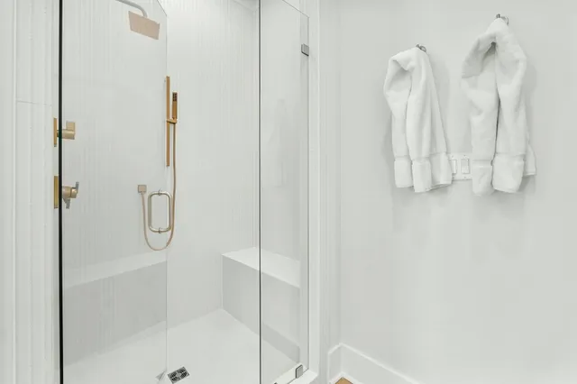 a bathroom with a glass shower door