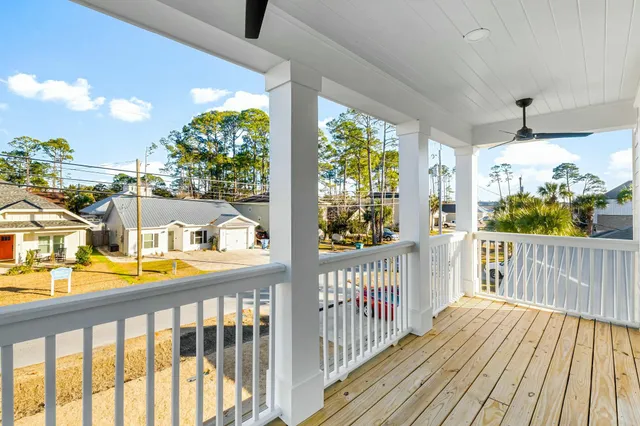 a view of a balcony with wooden floor