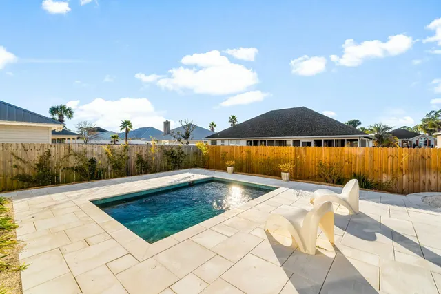 a view of swimming pool with seating space
