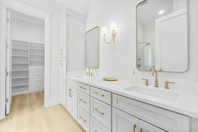 a bathroom with a double vanity sink and a mirror