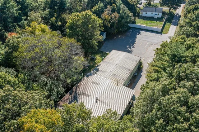 an aerial view of a house with swimming pool and garden