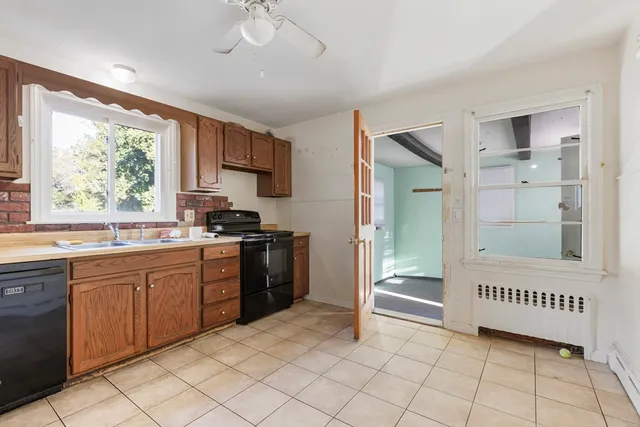 a kitchen with a refrigerator a sink and a window
