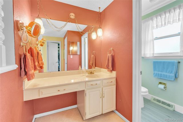 a bathroom with a sink a vanity and a mirror