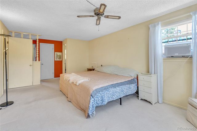 a bed sitting in a room next to a window