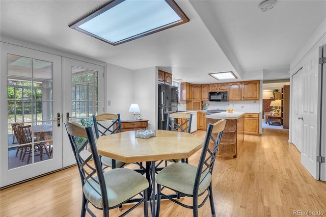 a dining room with furniture and wooden floor