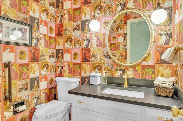 a bathroom with a sink and mirror with toilet