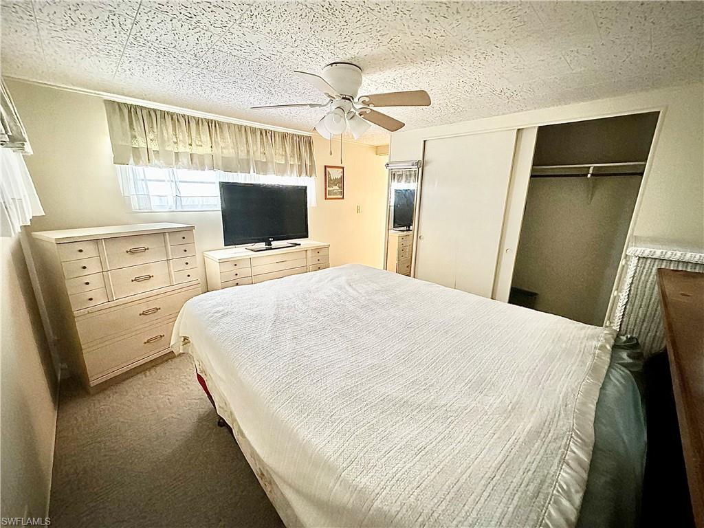26191 Kings Road Bonita Springs, FL 34135 - Photo 8 of 24 Bedroom with carpet, ceiling fan, and a closet