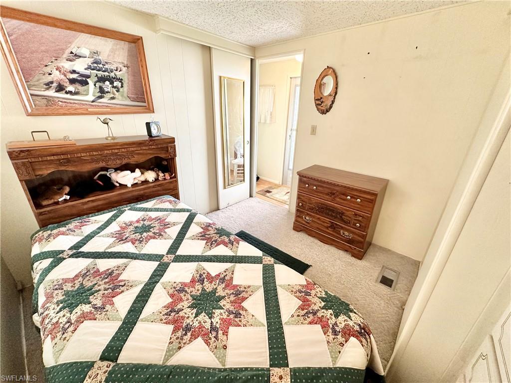 26191 Kings Road Bonita Springs, FL 34135 - Photo 10 of 24 Bedroom with carpet and a textured ceiling