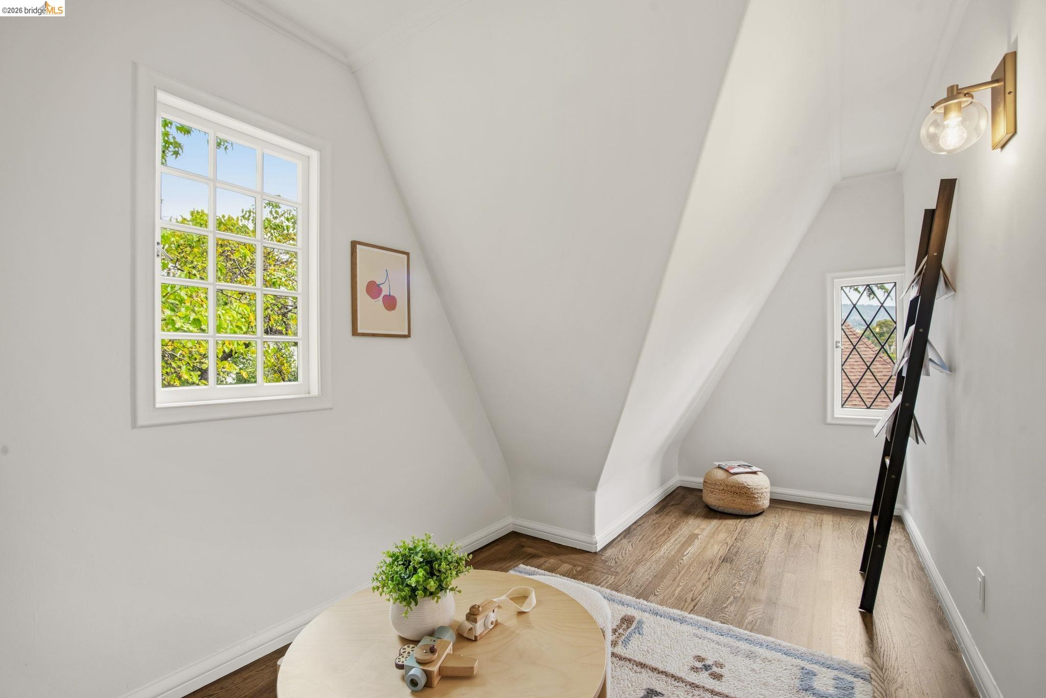 1087 Hubert Road Oakland, CA 94610 - Photo 31 of 67 Attic room featuring sloped ceilings, wood-finish flooring, and white baseboards