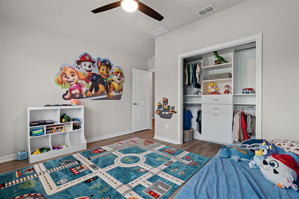 3112 Kingsgarden Road Denton, TX 76207 - Photo 20 of 38 Bedroom featuring wood-finish flooring, a ceiling fan with integrated lighting, and a white interior door