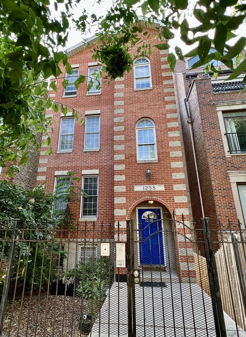 1238 North Cleaver Street, Unit 3 Chicago, IL 60642 - Photo 1 of 16 a view of a brick house with large windows