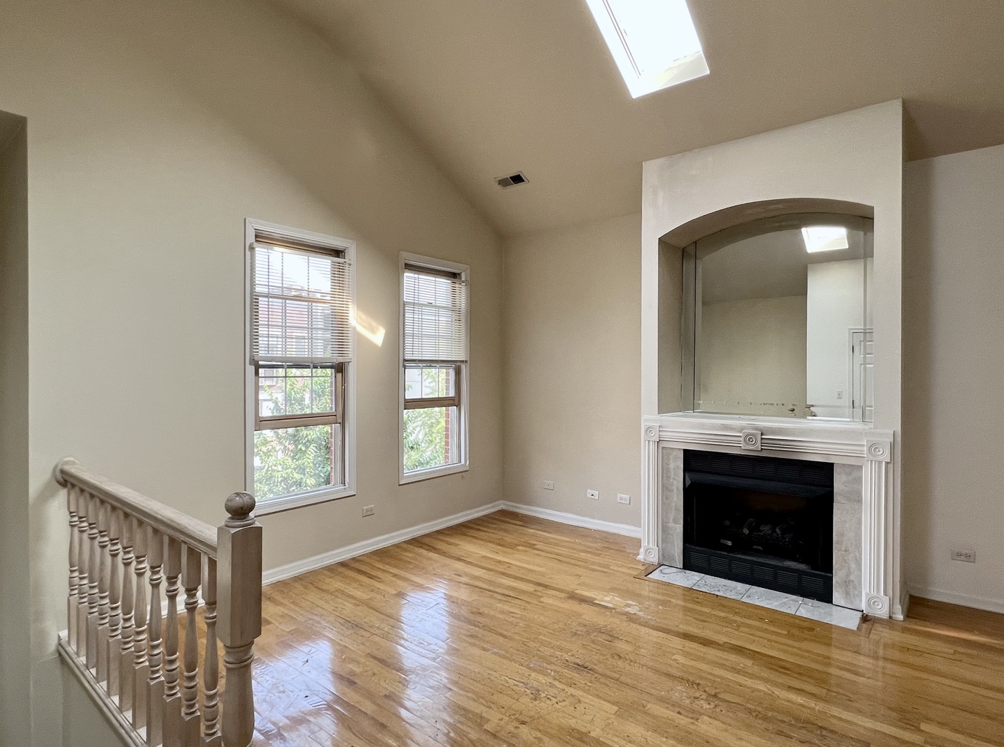 1238 North Cleaver Street, Unit 3 Chicago, IL 60642 - Photo 5 of 16 an empty room with windows and fireplace