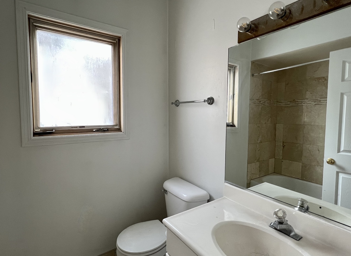 1238 North Cleaver Street, Unit 3 Chicago, IL 60642 - Photo 10 of 16 a bathroom with a sink toilet and mirror