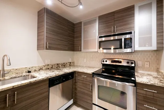 a kitchen with a sink stove and microwave