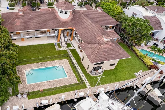 an aerial view of a house with a yard