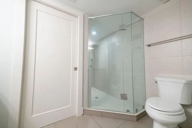 a bathroom with a shower and a toilet