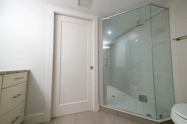 a bathroom with a shower a toilet and sink